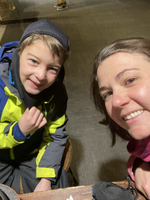 Elizabeth and her nephew warming up on the ski slopes.