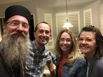 Having dinner with our priest and his wife.