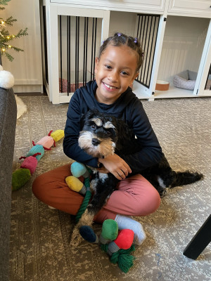 A photo before school with Rosie’s favorite dog toy - her Christmas lights rug rope.
