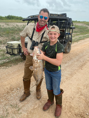Fishing at the ranch with our godson.