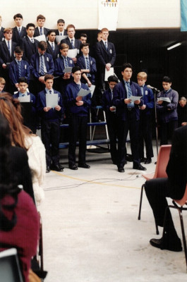 Rudolph singing in the choir.