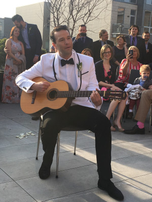 David playing a love song with his Grandma’s guitar with his family supporting behind him
