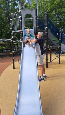 Grampy helps Henry ride the big boy slide!
