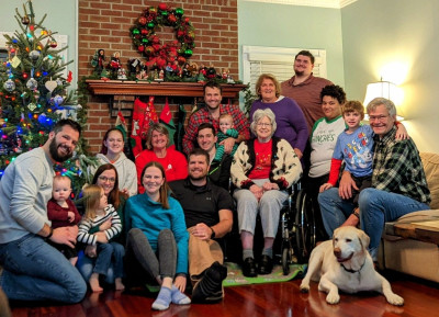 Four generations at Christmas: Uncle Stephen, cousins Nicole and Alexandra, Aunt Leslie, cousin Natalie, Aunt Jenn, Great Aunt Laura, Uncle Michael, Baba, Dada, Henry, Great-Grandma Susie, Grammy, cousins AJ, Andi, and Evan, Grampy, and Memphis